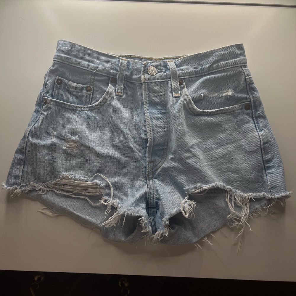 Light wash, distressed Levi 501 shorts.